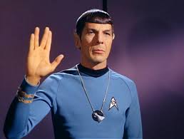 Mr. Spock wearing the Vulcan I.D.I.C. and performing the Vulcan salute.